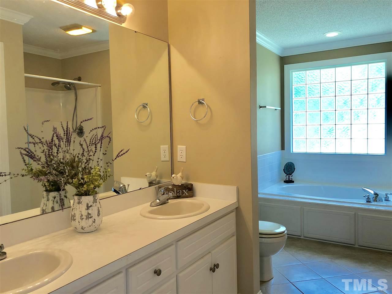 8211 Byrd Road Sims, NC 27880 - Photo 6 of 8 a bathroom with a granite countertop sink a toilet a mirror and shower