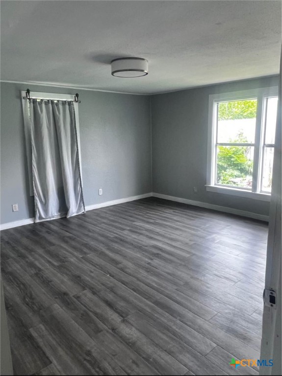 706 East Virginia Avenue Victoria, TX 77901 - Photo 4 of 9 a view of wooden floor and windows in a room