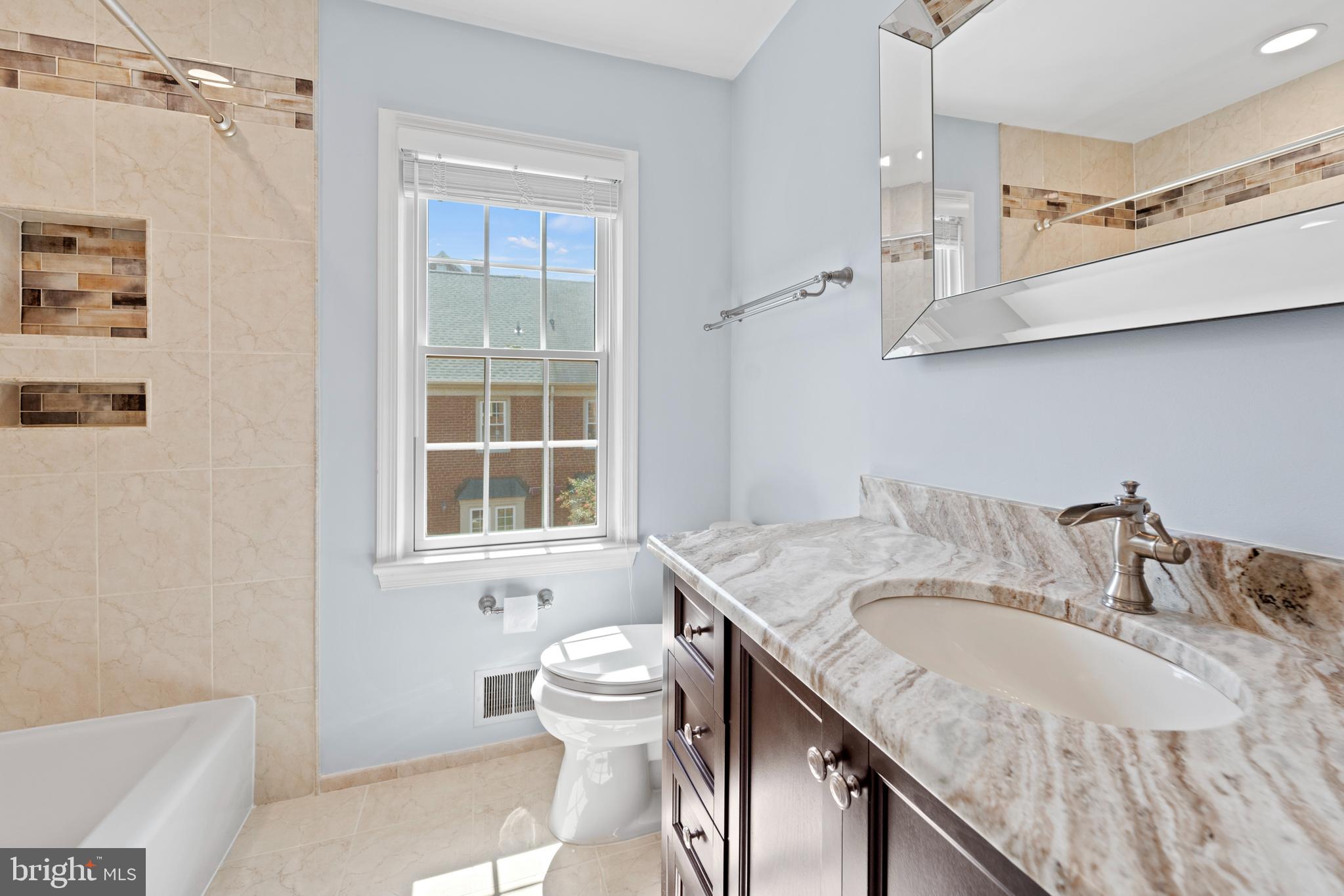 1235 Portner Road Alexandria, VA 22314 - Photo 12 of 23 a bathroom with a granite countertop sink a toilet and a bathtub