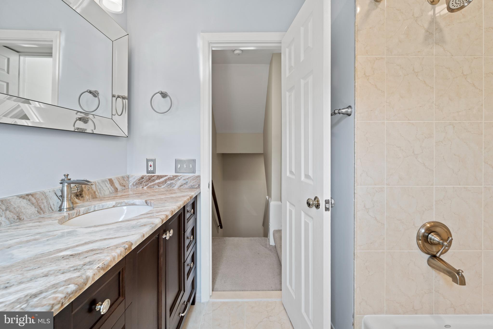 1235 Portner Road Alexandria, VA 22314 - Photo 13 of 23 a bathroom with a granite countertop sink and a mirror