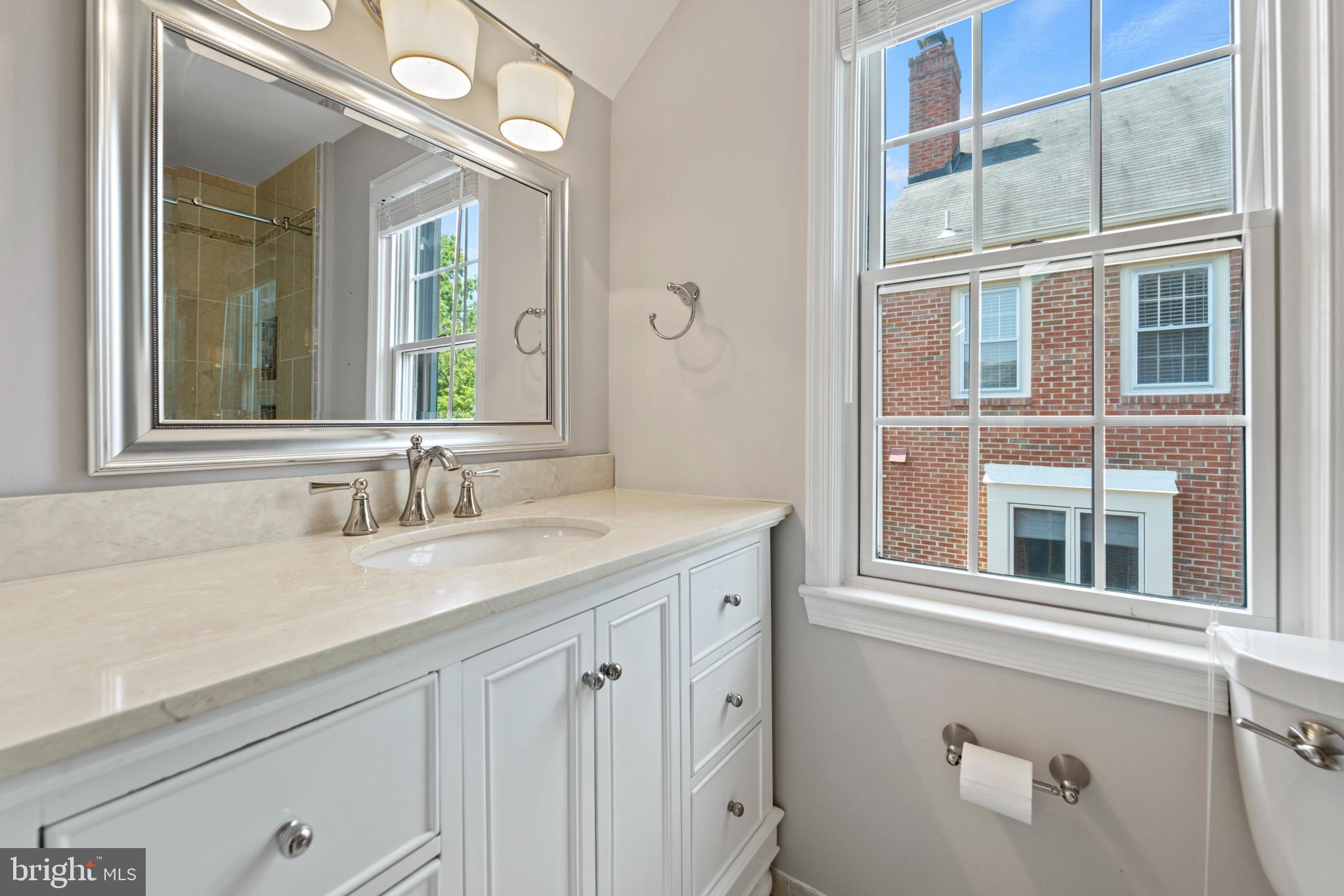 1235 Portner Road Alexandria, VA 22314 - Photo 20 of 23 a bathroom with a granite countertop sink and a mirror