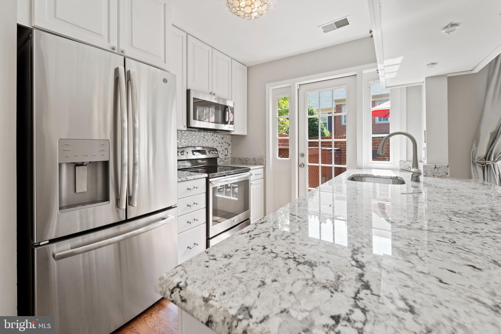 1235 Portner Road Alexandria, VA 22314 - Photo 6 of 23 a kitchen with stainless steel appliances a refrigerator sink and cabinets