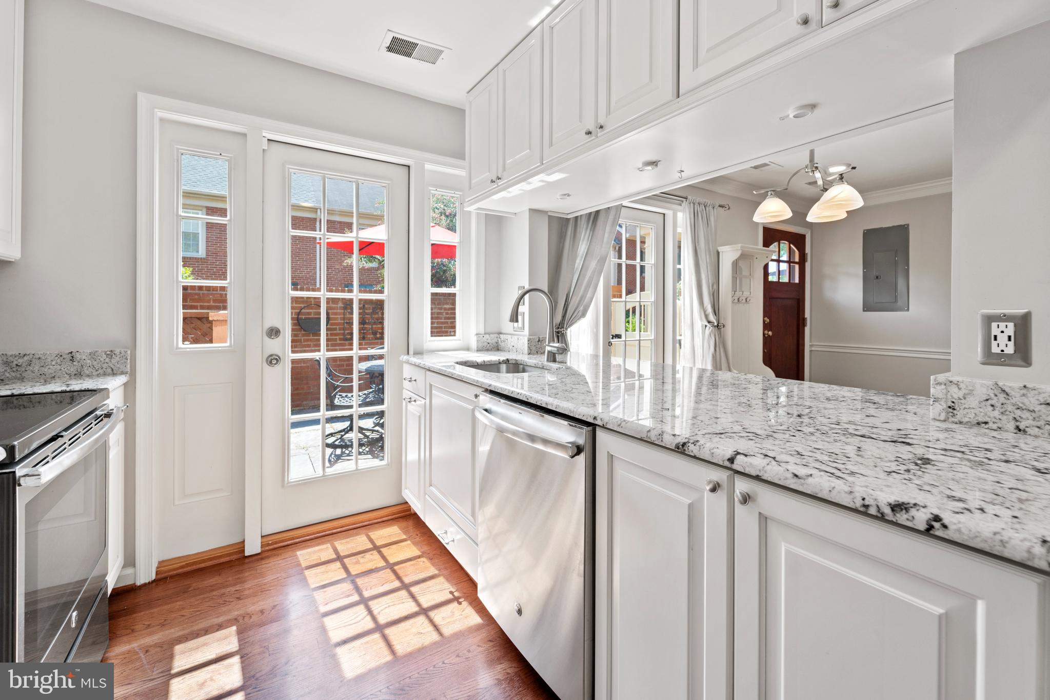 1235 Portner Road Alexandria, VA 22314 - Photo 7 of 23 a kitchen with granite countertop a sink stove and cabinets