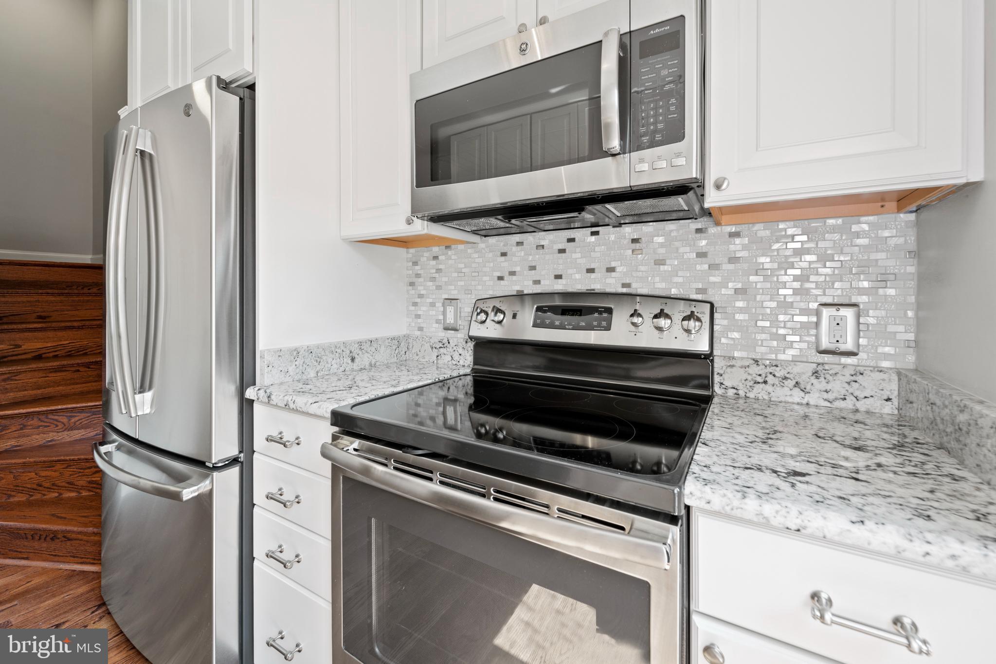 1235 Portner Road Alexandria, VA 22314 - Photo 8 of 23 a kitchen with granite countertop a stove and a microwave