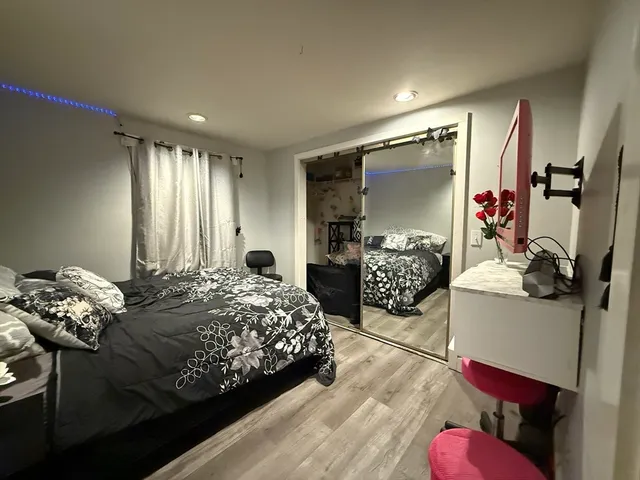 a bed room with a bed window and dresser