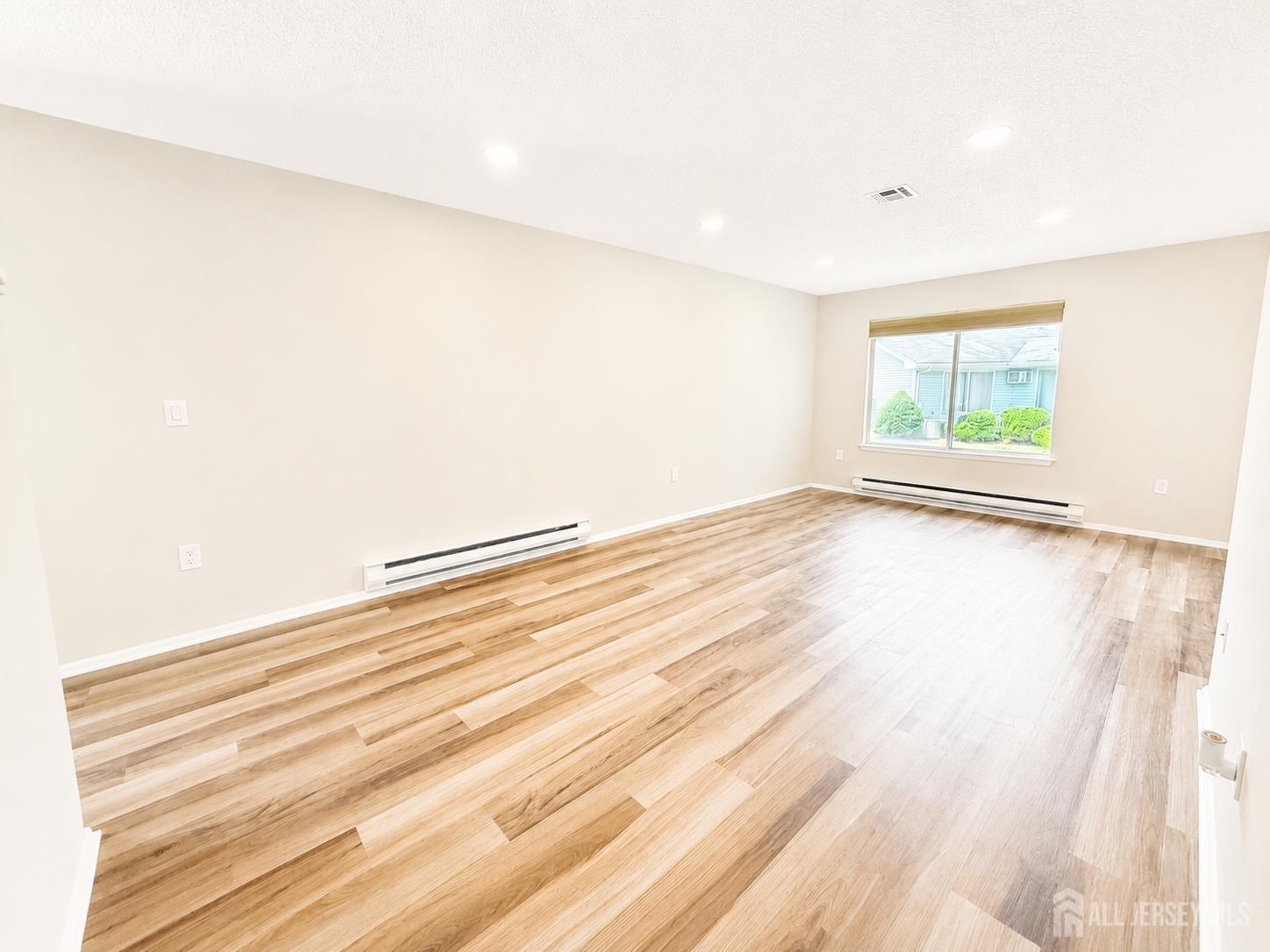 621 A Deal Road Monroe Township, NJ 08831 - Photo 26 of 27 a view of empty room with wooden floor and fan