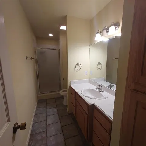 a bathroom with a sink shower and a mirror