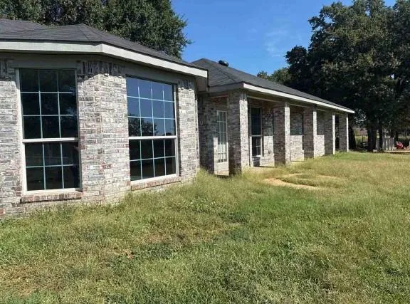 a front view of a house with a garden