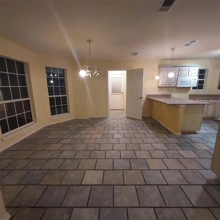 a view of a kitchen with a sink and cabinets