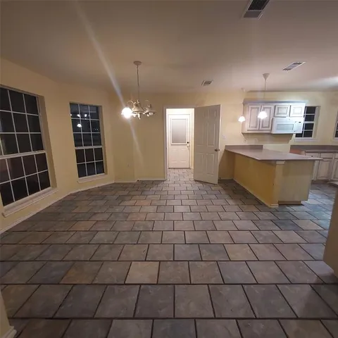 a view of a kitchen with a sink and cabinets
