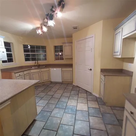 a open kitchen with stainless steel appliances granite countertop a sink and dishwasher a refrigerator with a granite countertops