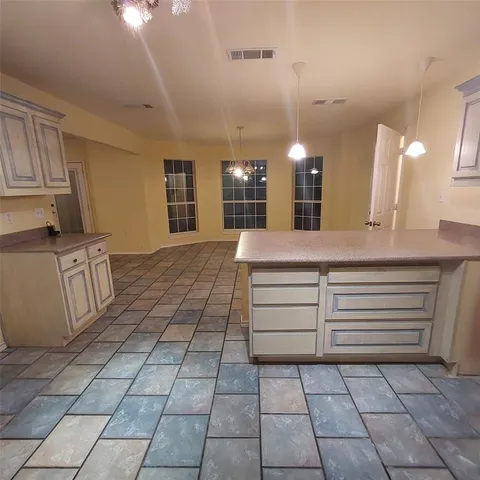 a view of a kitchen with a sink and cabinets