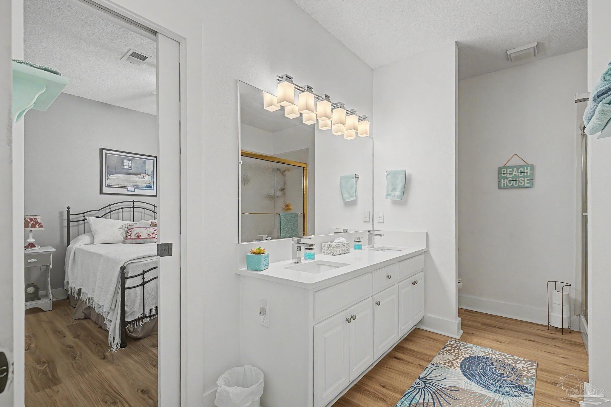 2005 Riviera Lane South Navarre, FL 32566 - Photo 43 of 70 a spacious bathroom with a double vanity sink and a mirror
