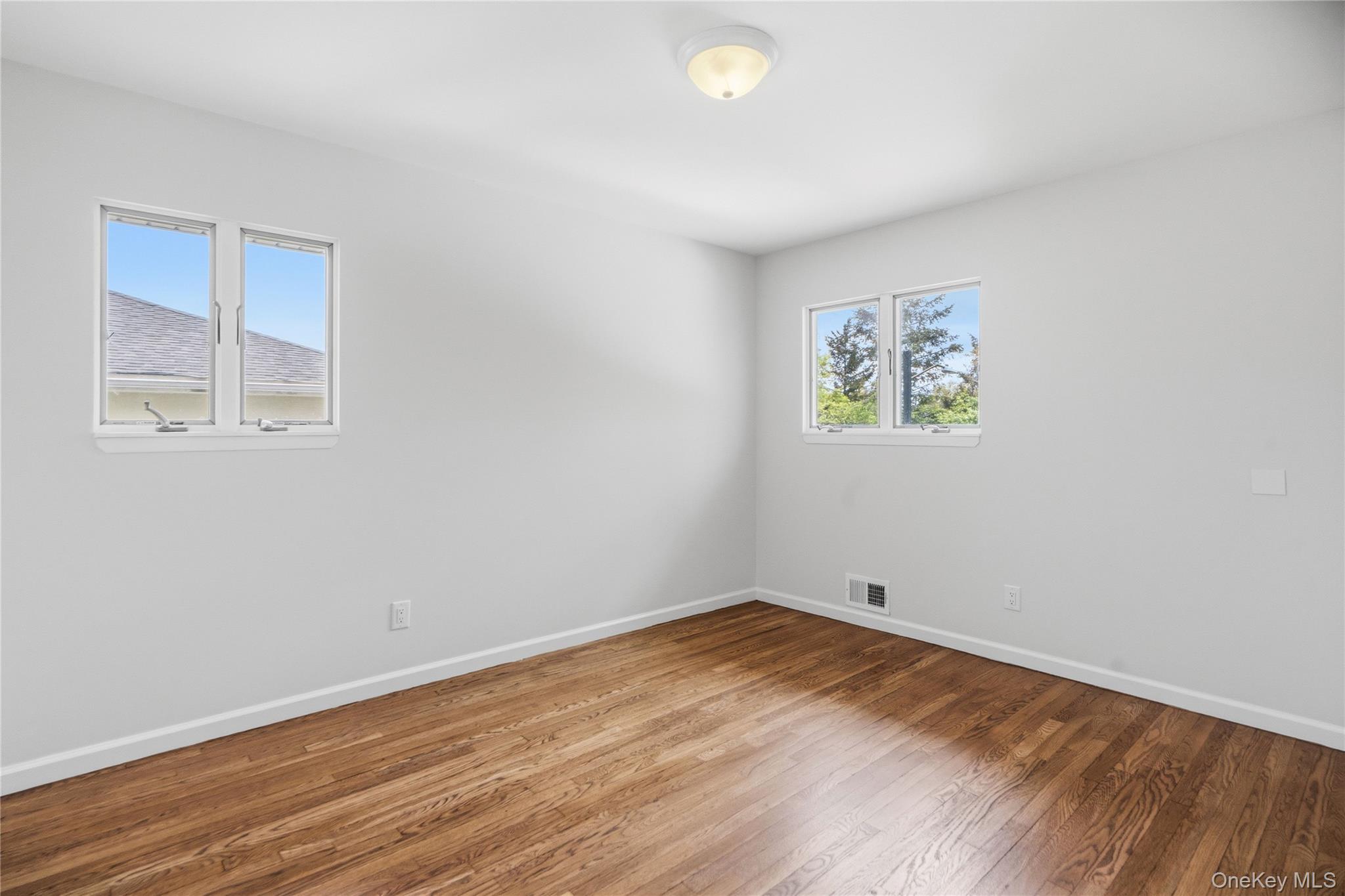 183 North Marginal Road Jericho, NY 11753 - Photo 19 of 28 Second Bedroom with Hardwood flooring with white baseboards