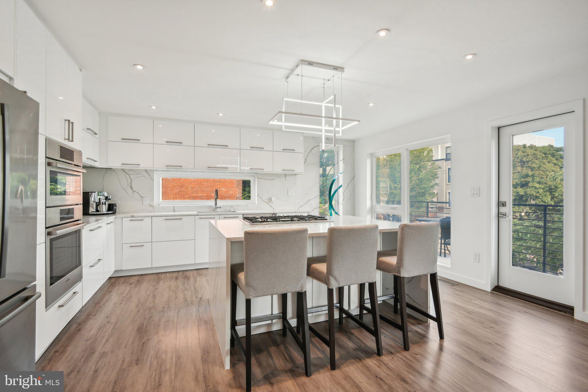 128 17th Street Northeast Washington, DC 20002 - Photo 14 of 42 a kitchen with stainless steel appliances a dining table chairs and wooden floor