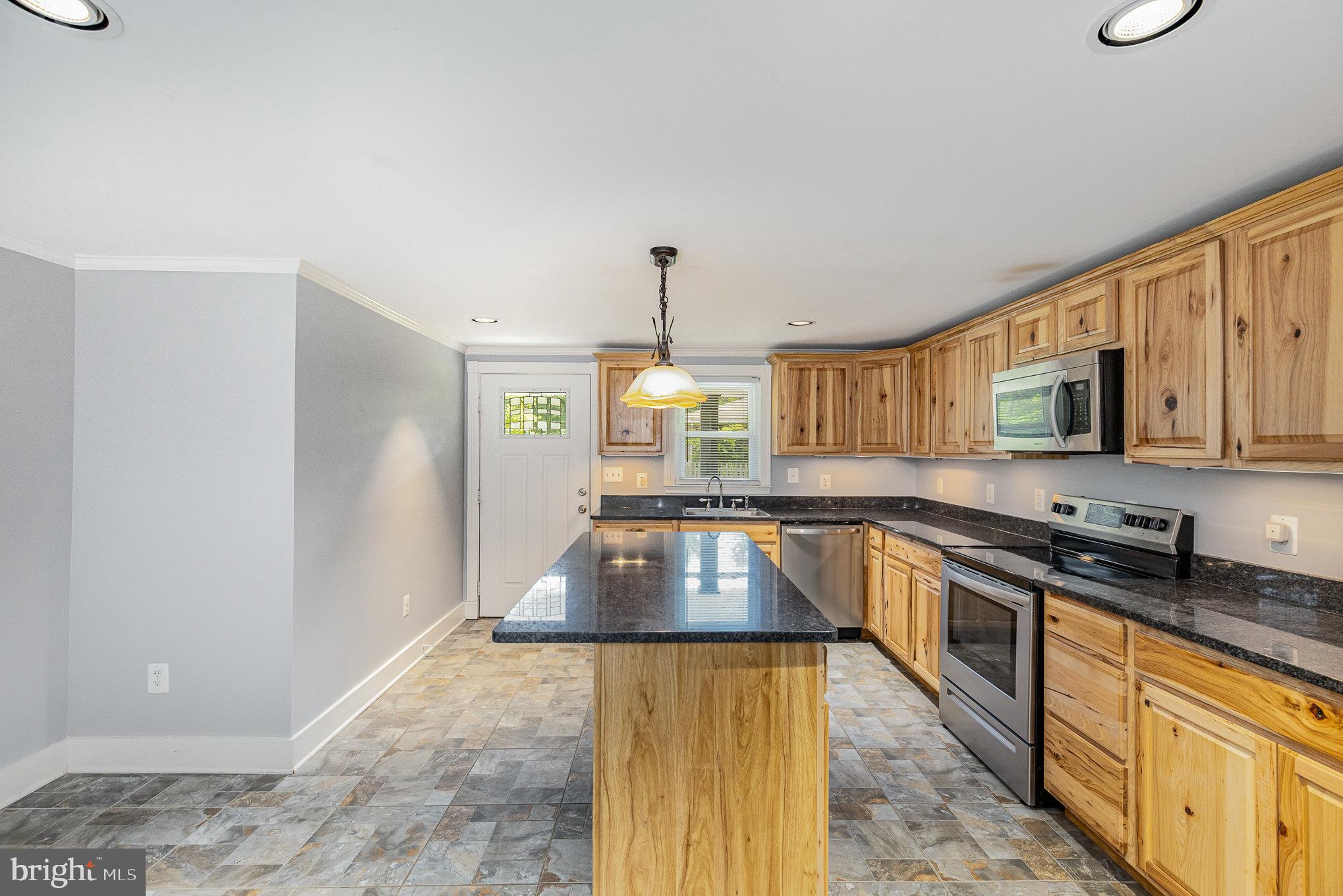 1030 White Oak Road Fredericksburg, VA 22405 - Photo 11 of 25 a kitchen with stainless steel appliances granite countertop a stove a sink and a microwave