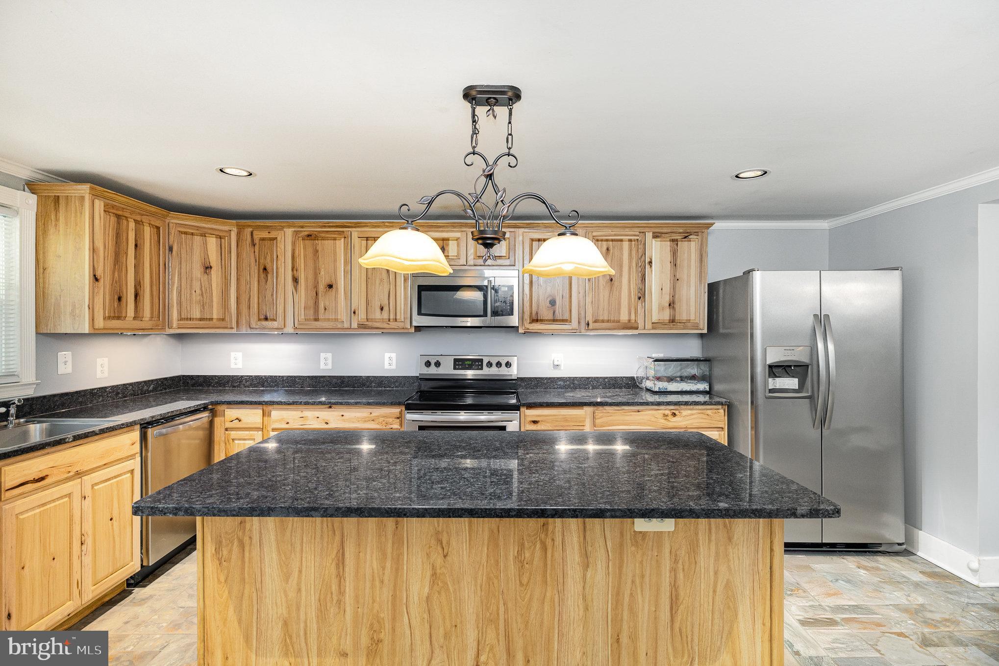 1030 White Oak Road Fredericksburg, VA 22405 - Photo 12 of 25 a kitchen with stainless steel appliances granite countertop a sink a stove and a wooden floors
