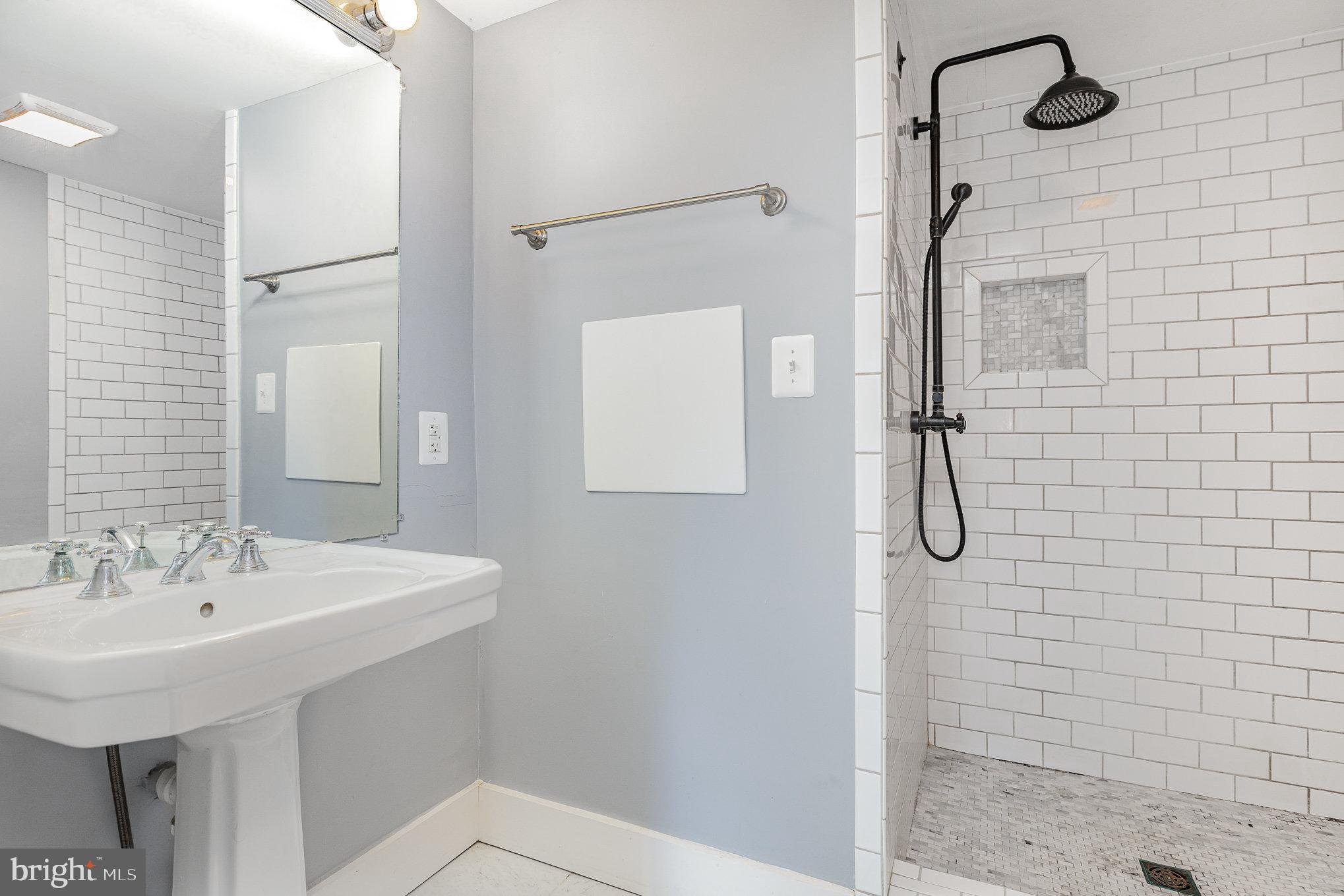 1030 White Oak Road Fredericksburg, VA 22405 - Photo 16 of 25 a bathroom with a sink a mirror and shower