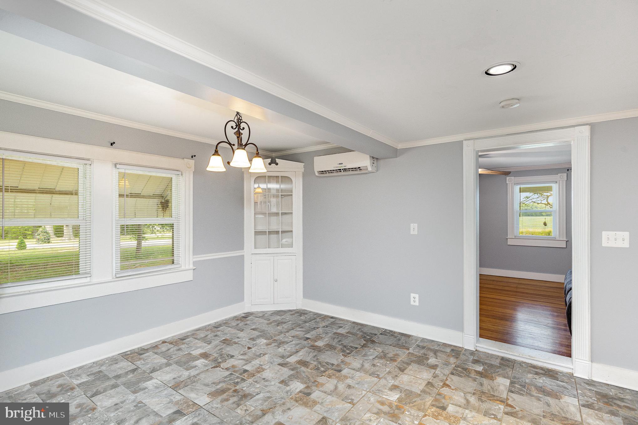 1030 White Oak Road Fredericksburg, VA 22405 - Photo 7 of 25 a view of a big room with windows and chandelier fan
