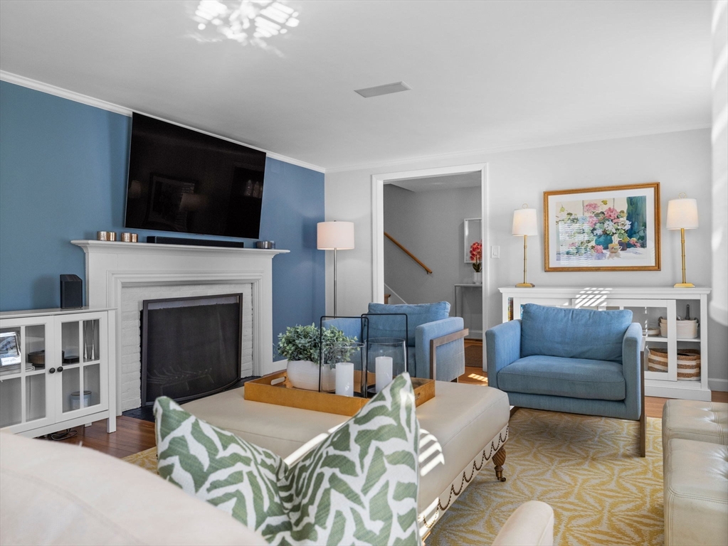 7 Madison Road Wellesley, MA 02481 - Photo 12 of 27 a living room with furniture a flat screen tv and a fireplace