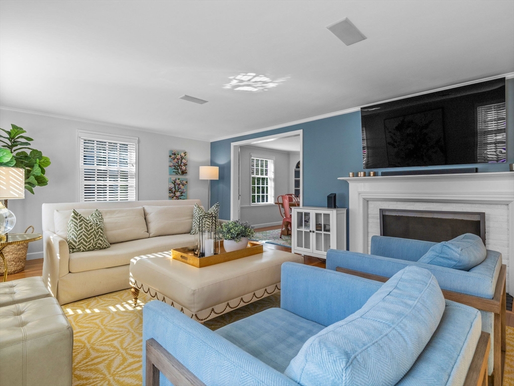 7 Madison Road Wellesley, MA 02481 - Photo 13 of 27 a living room with furniture a flat screen tv and a fireplace