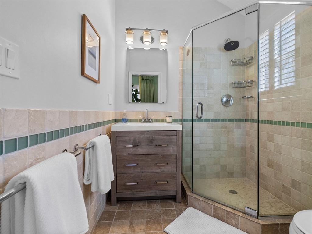 7 Madison Road Wellesley, MA 02481 - Photo 17 of 27 a bathroom with a shower sink and mirror