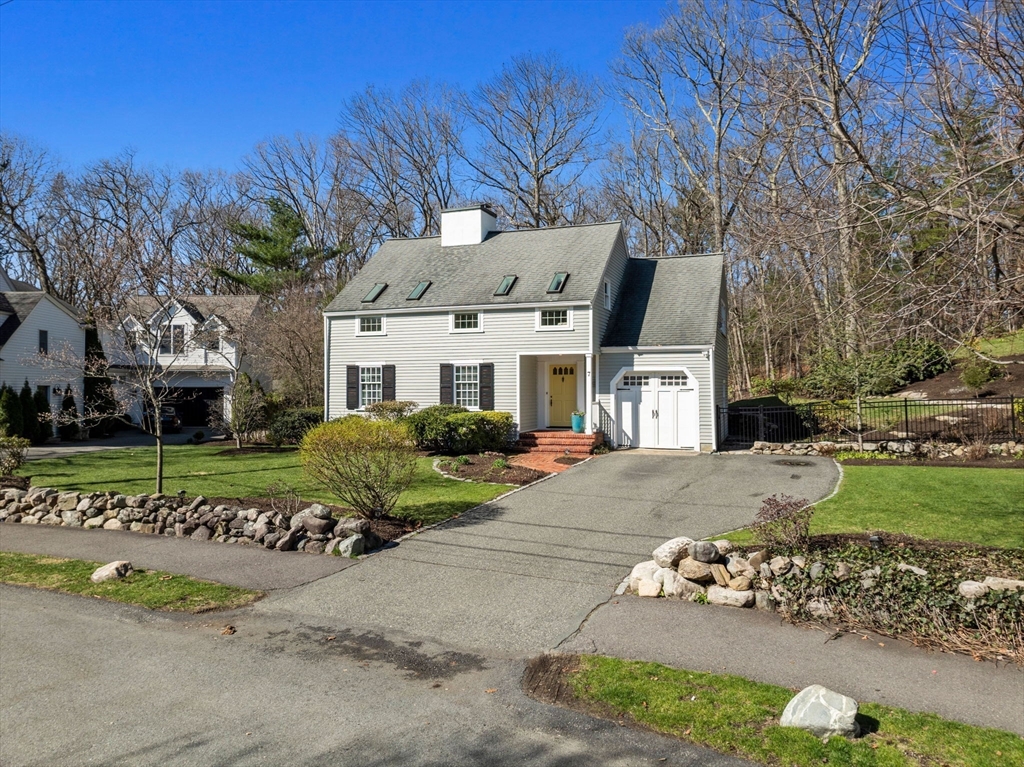 7 Madison Road Wellesley, MA 02481 - Photo 2 of 27 a front view of a house with a garden and trees