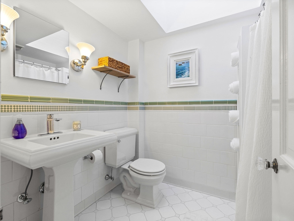 7 Madison Road Wellesley, MA 02481 - Photo 21 of 27 a bathroom with a sink a toilet and mirror