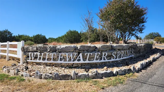a view of a house with a yard with wooden fence
