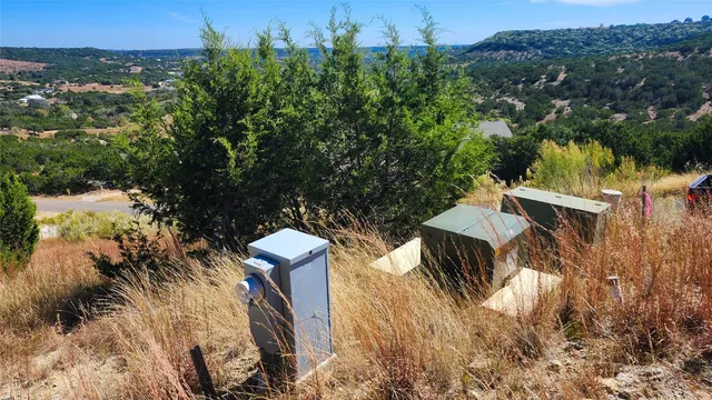 a view of a chairs and table in the backyard