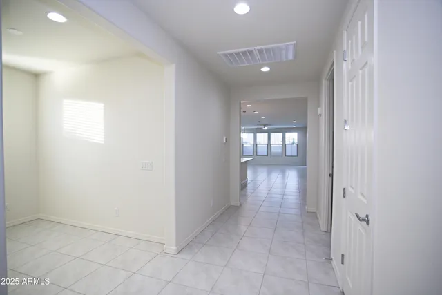 an empty room with a empty space and windows