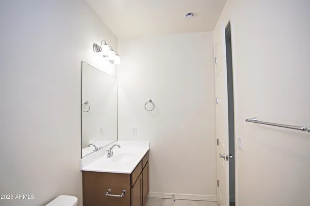 a large kitchen with a large counter top stainless steel appliances and cabinets