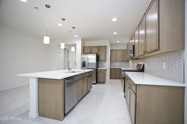 a kitchen with granite countertop white cabinets and stainless steel appliances
