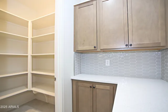 a kitchen with a sink a counter top stainless steel appliances and cabinets