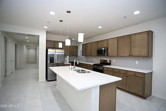 a view of a kitchen with a refrigerator and a sink