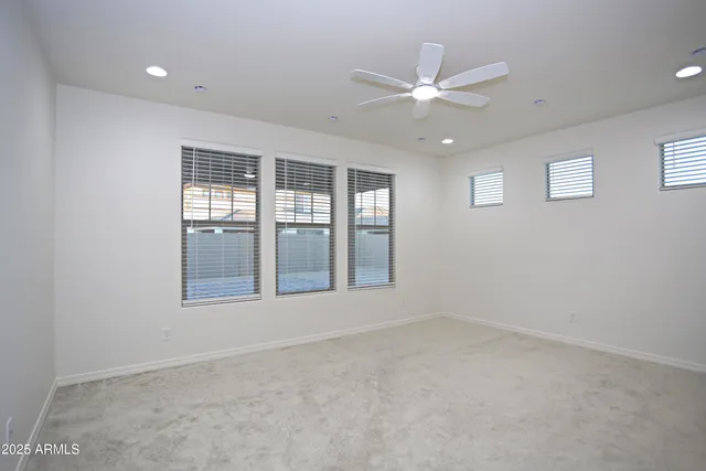 an empty room with fan and a ceiling fan