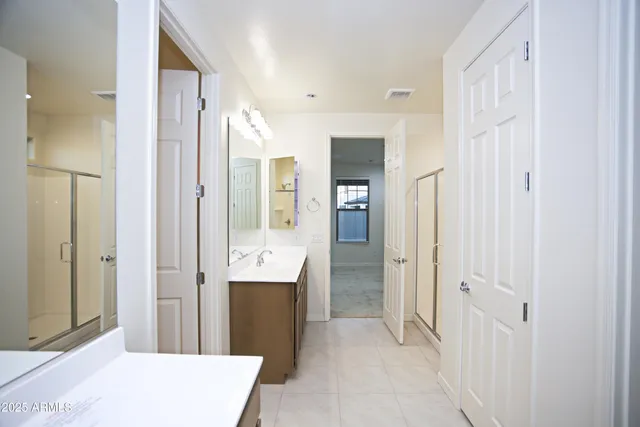 a bathroom with a double vanity sink and mirror