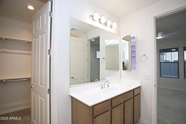 a view of walk in closet with empty racks