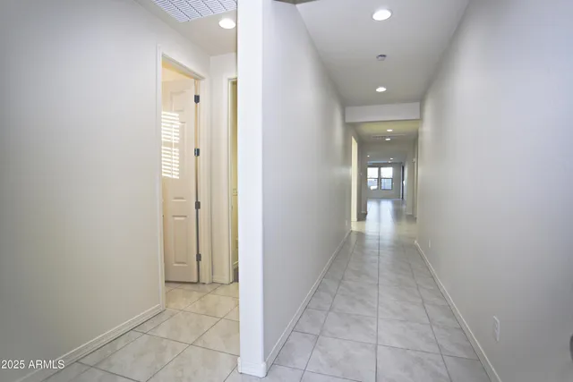 a view of a hallway with wooden shelves