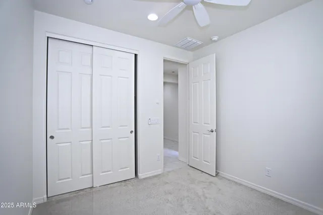 an empty room with a ceiling fan