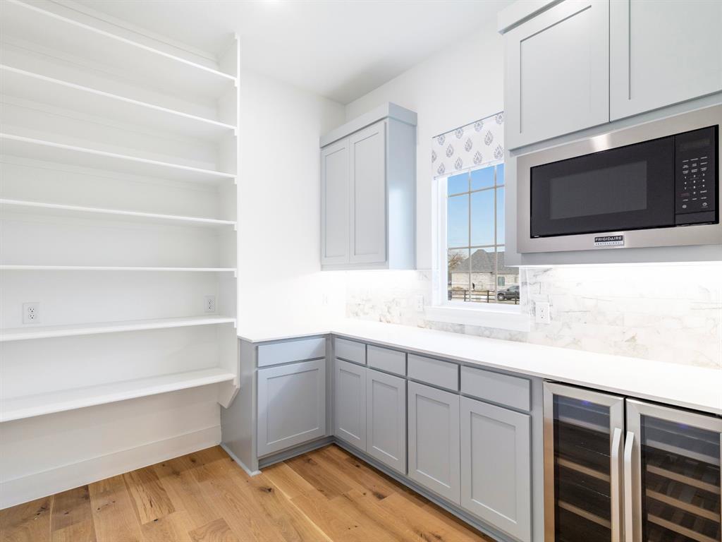 7 William Brewer Road Collinsville, TX 76233 - Photo 12 of 16 a kitchen with a sink cabinets and a microwave