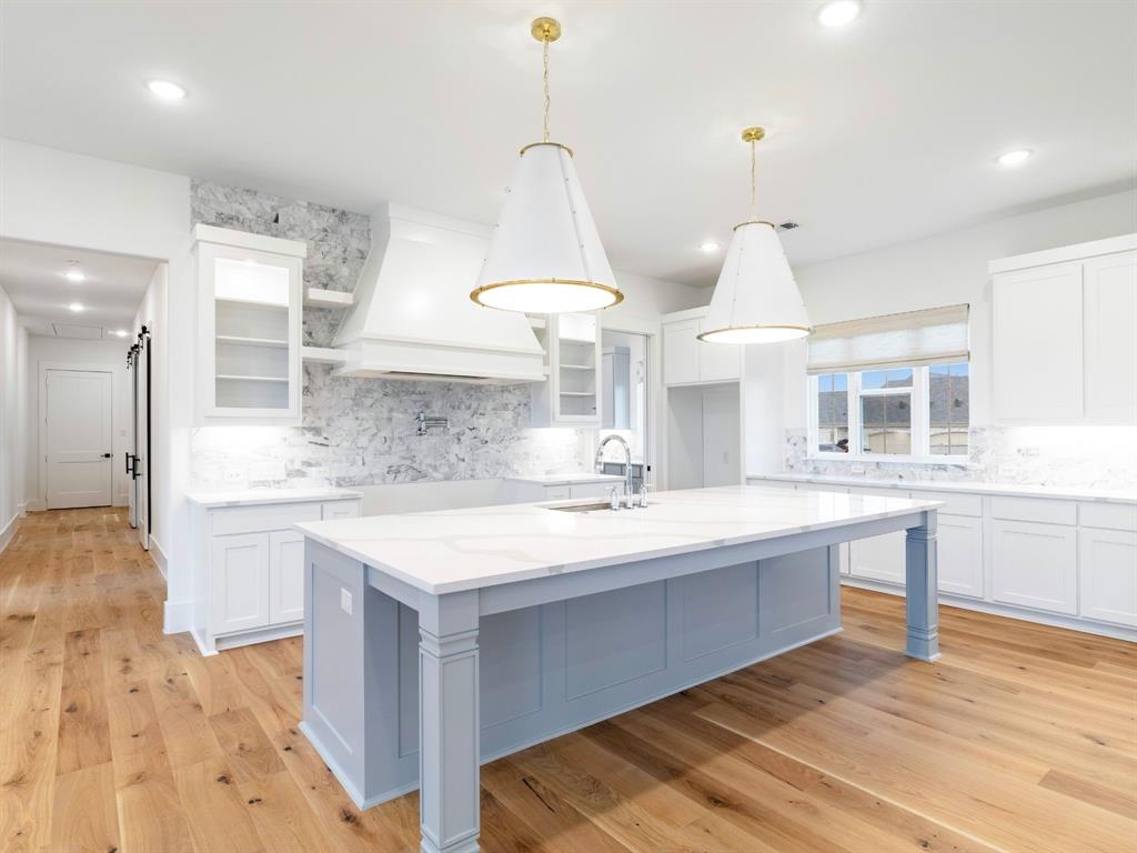 7 William Brewer Road Collinsville, TX 76233 - Photo 13 of 16 a large kitchen with kitchen island a sink stainless steel appliances and cabinets