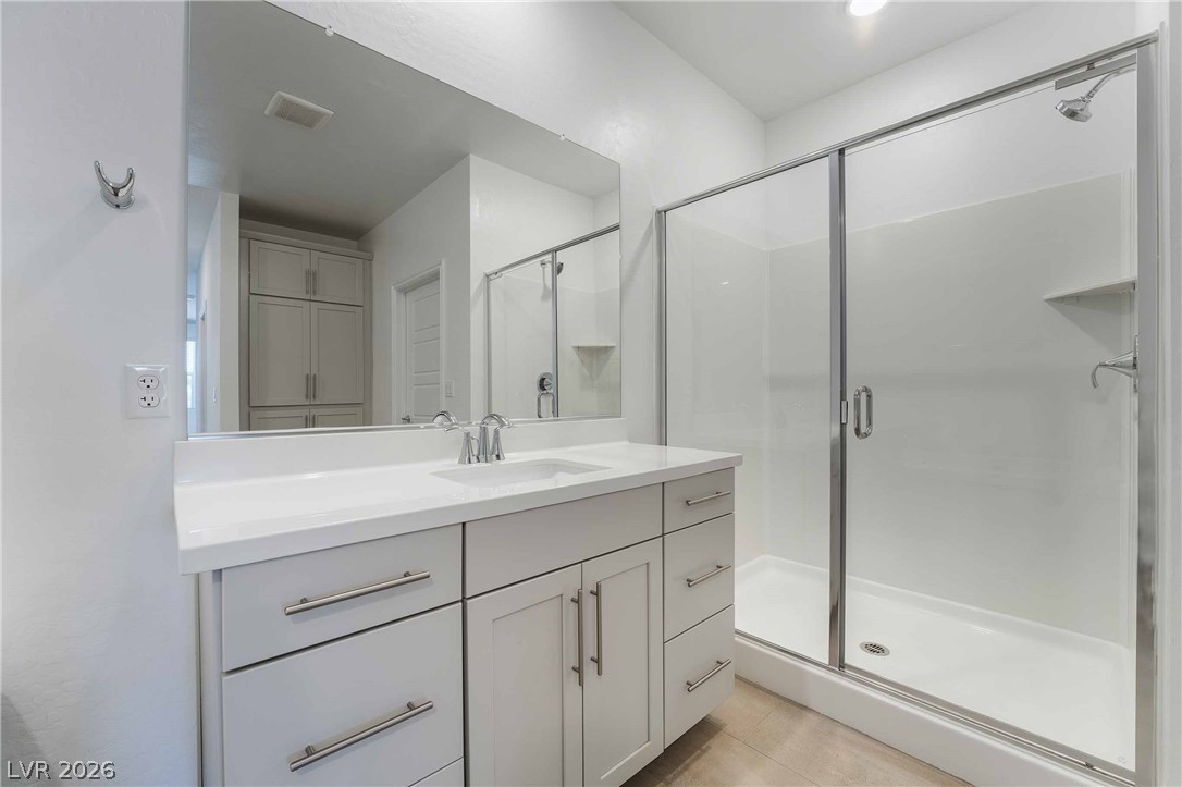 2555 Hampton Road, Unit 10202 Henderson, NV 89052 - Photo 32 of 35 Modern cabinetry and a spacious walk-in shower highlight this bright, clean bathroom space.