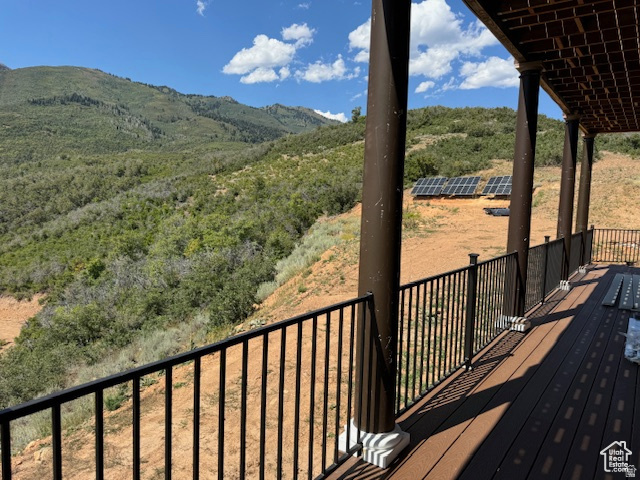 6909 East Spring Drive, Unit 19 Springville, UT 84663 - Photo 72 of 118 Expansive outdoor deck featuring composite decking, dark metal railings, and decorative columns