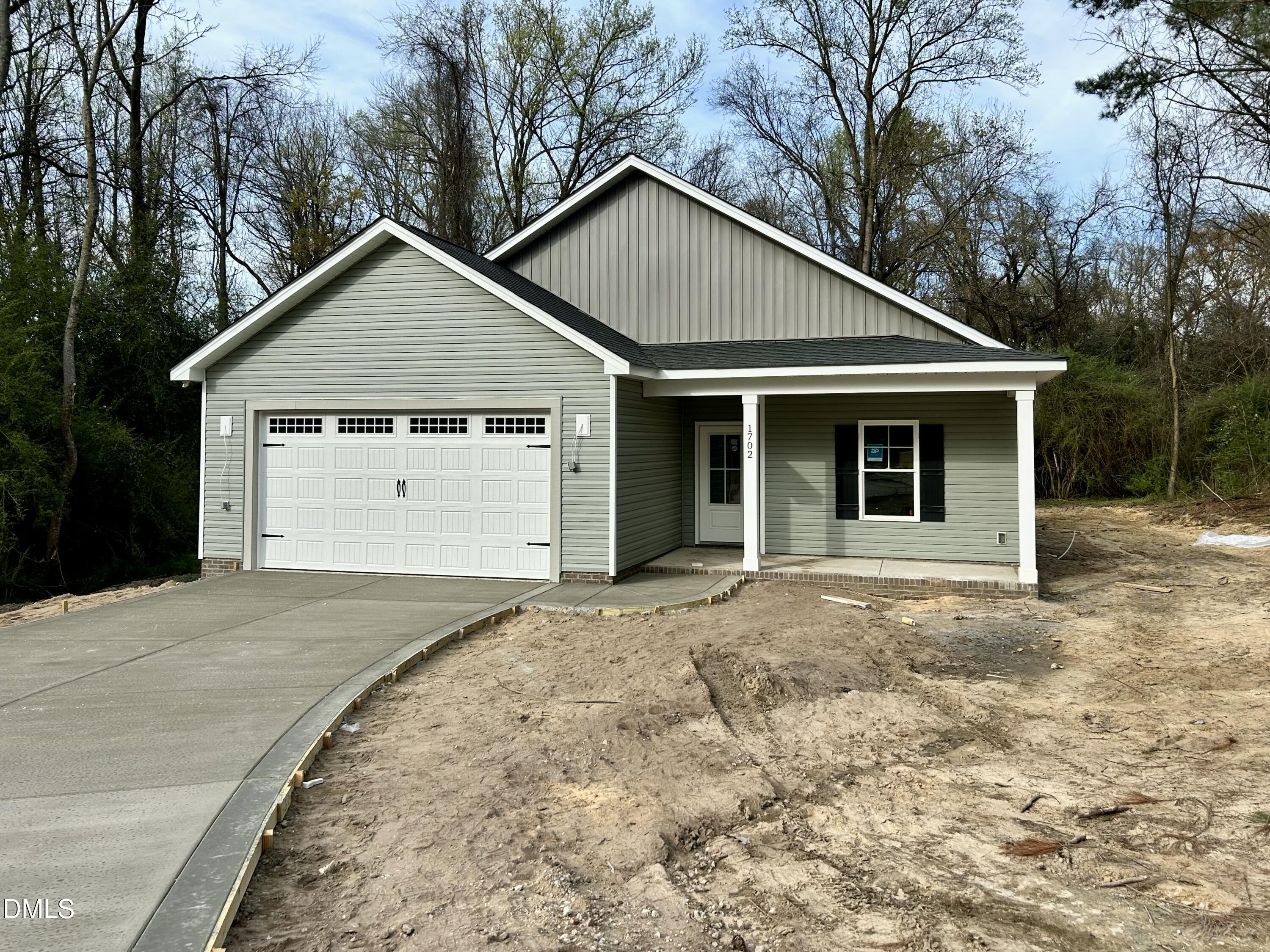 1702 Cardinal Drive Deep Run, NC 28525 - Photo 1 of 21 a front view of a house with a yard and garage
