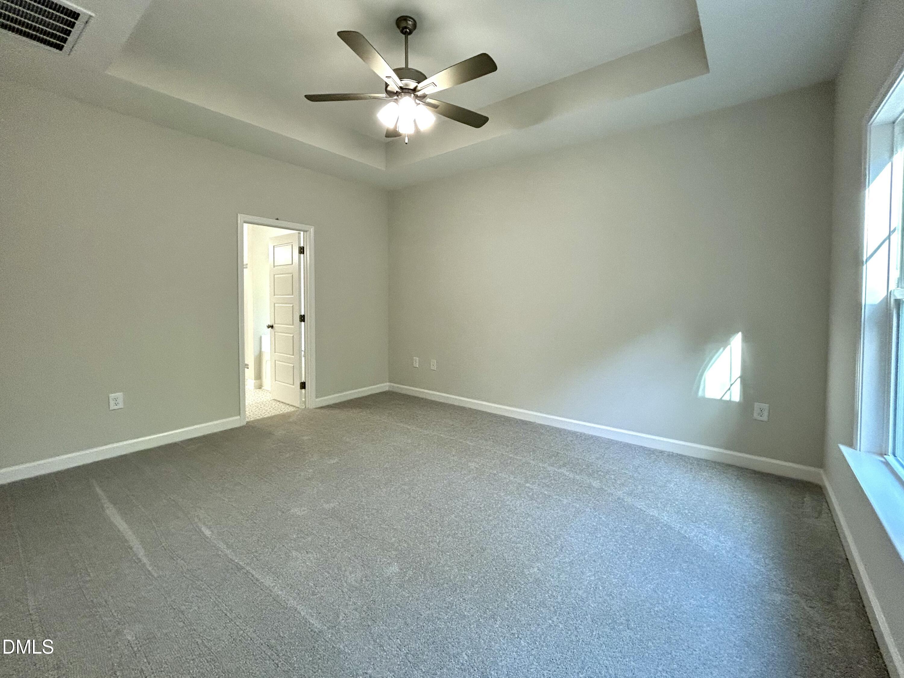 1702 Cardinal Drive Deep Run, NC 28525 - Photo 18 of 21 an empty room with a empty space and a ceiling fan