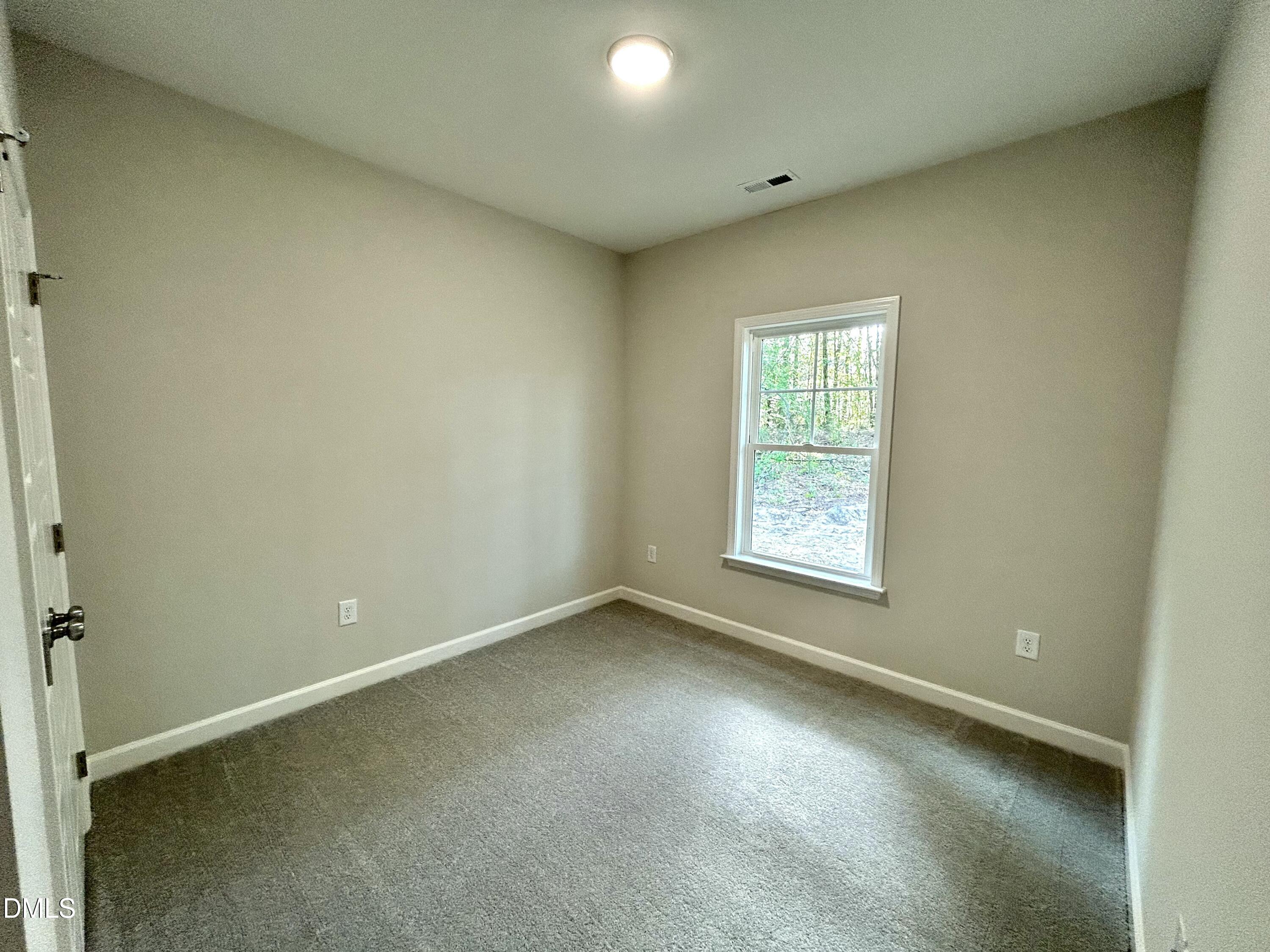 1702 Cardinal Drive Deep Run, NC 28525 - Photo 3 of 21 an empty room with a window