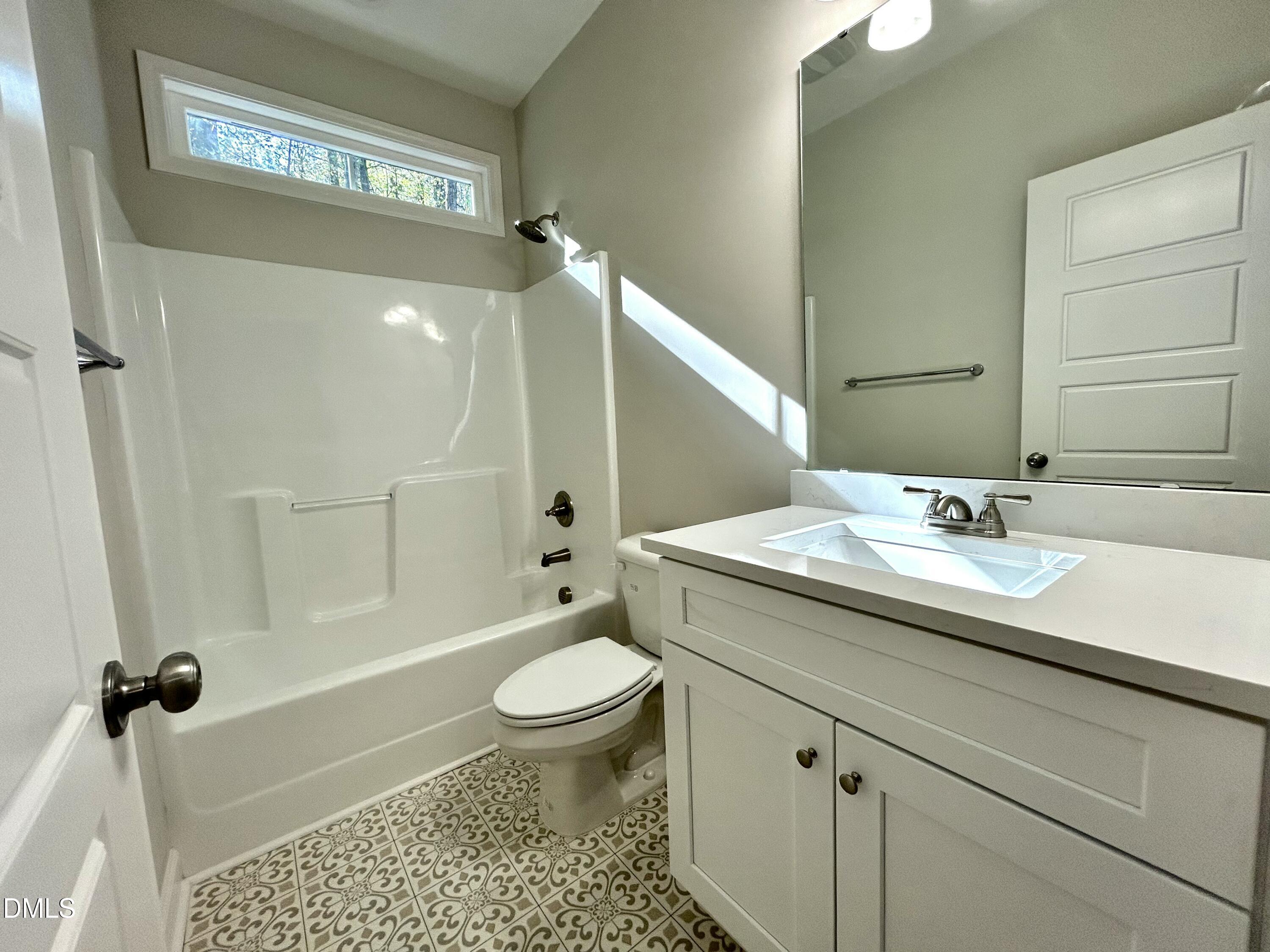 1702 Cardinal Drive Deep Run, NC 28525 - Photo 4 of 21 a bathroom with a sink a toilet and shower