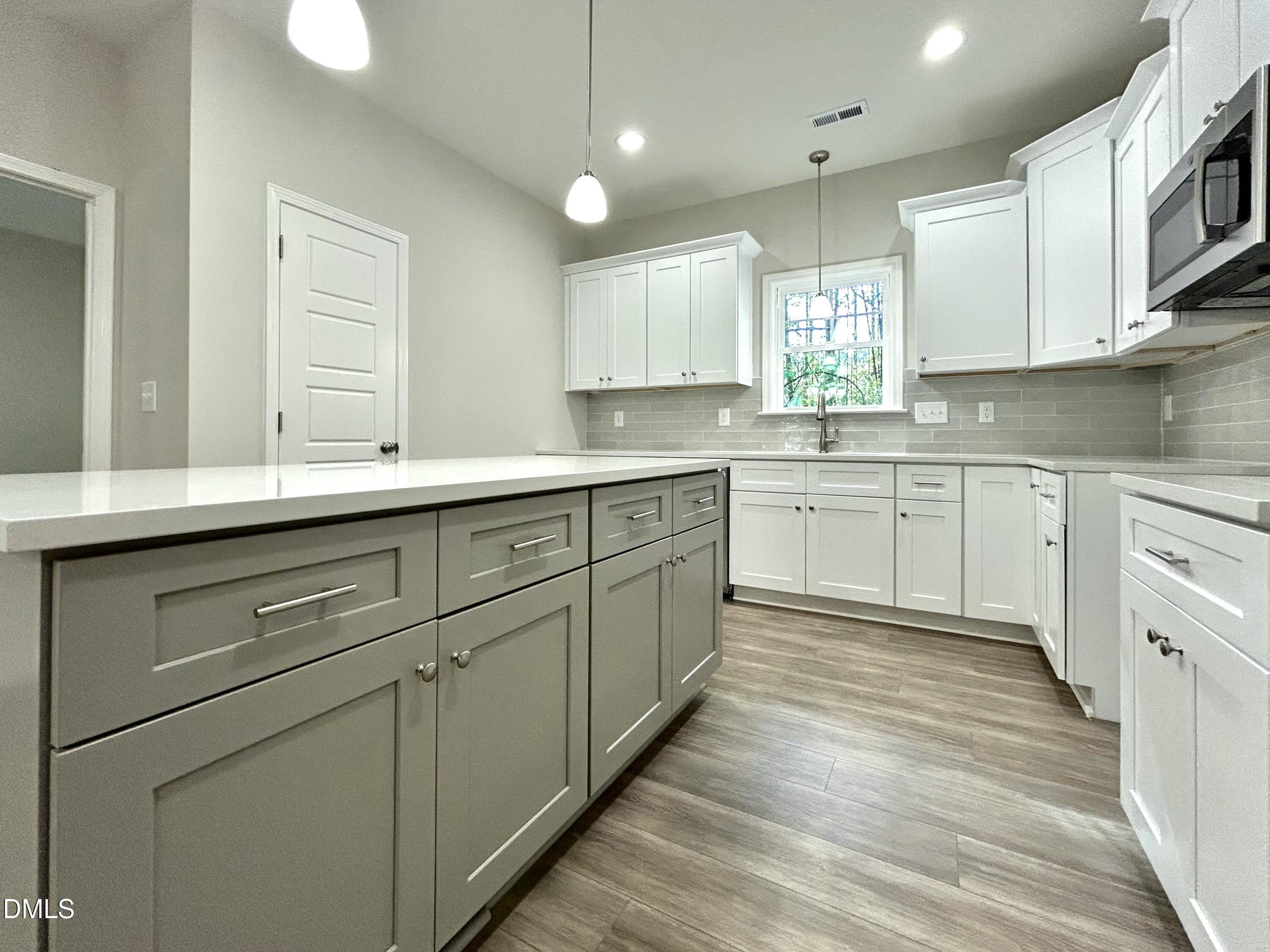 1702 Cardinal Drive Deep Run, NC 28525 - Photo 7 of 21 a kitchen with white cabinets appliances and a sink
