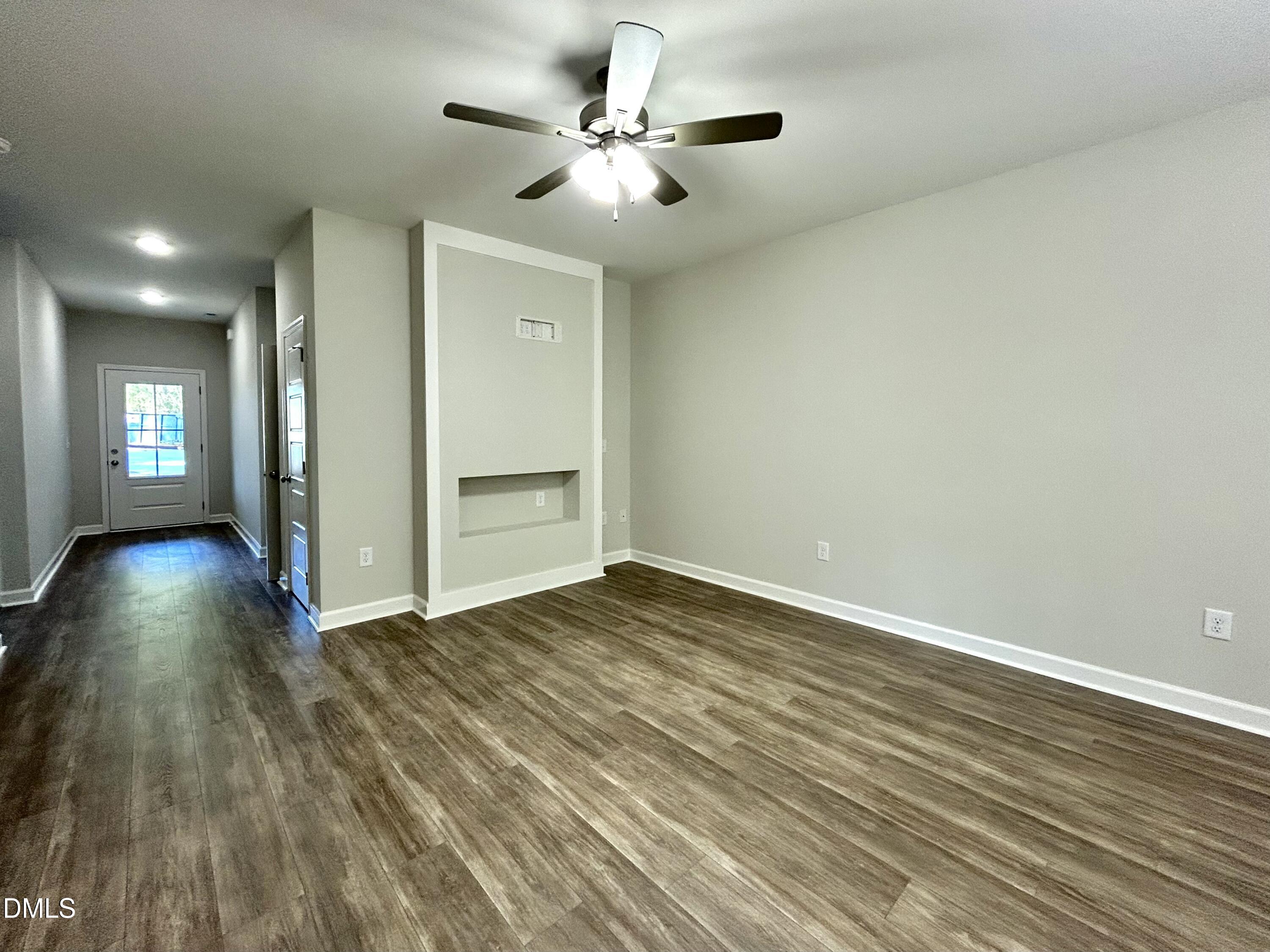 1702 Cardinal Drive Deep Run, NC 28525 - Photo 8 of 21 an empty room with wooden floor and windows